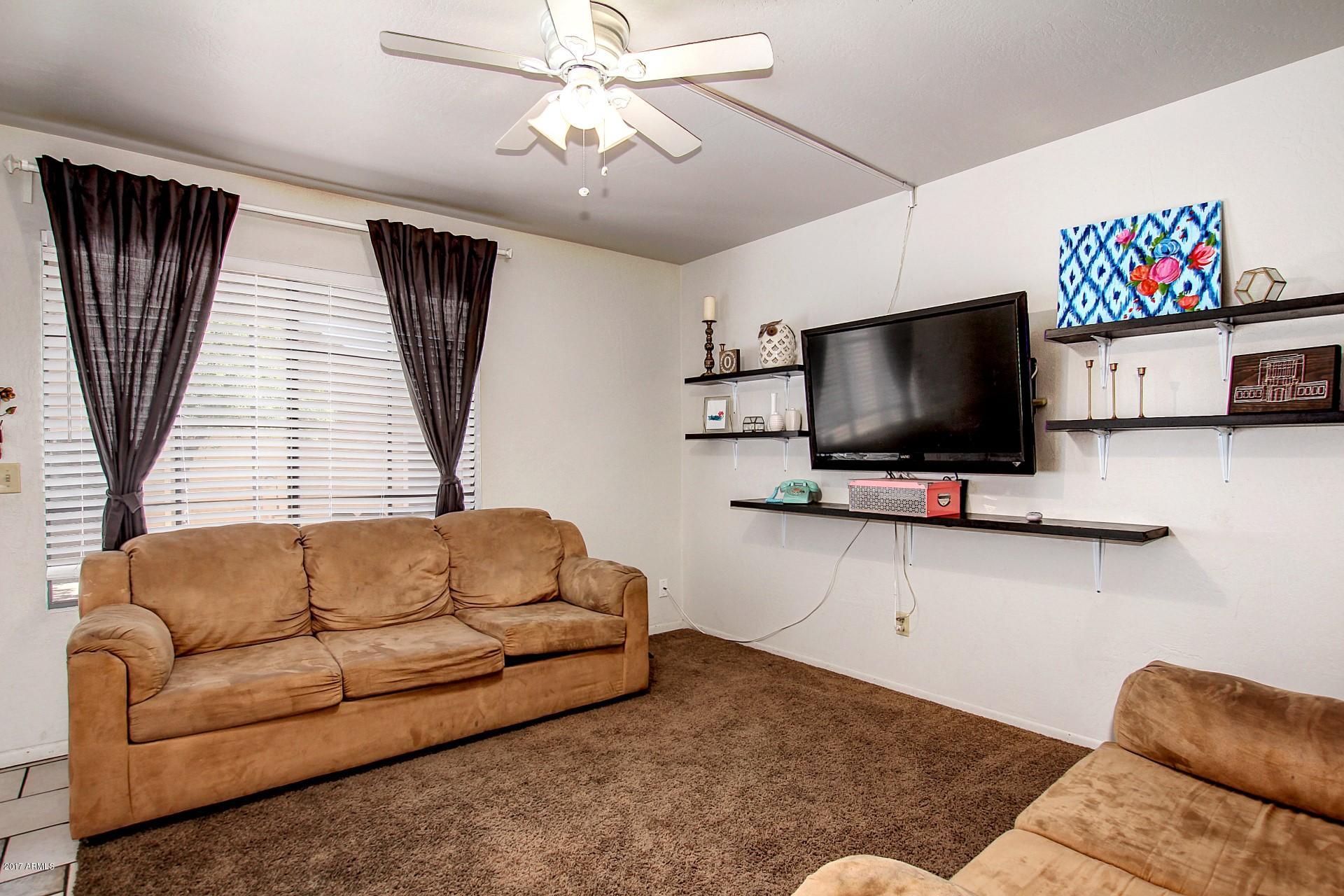 2455 East Broadway Road, Unit 93 Mesa, AZ 85204 - Photo 8 of 26 a living room with furniture and a flat screen tv
