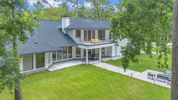 a aerial view of a house with a yard table and chairs