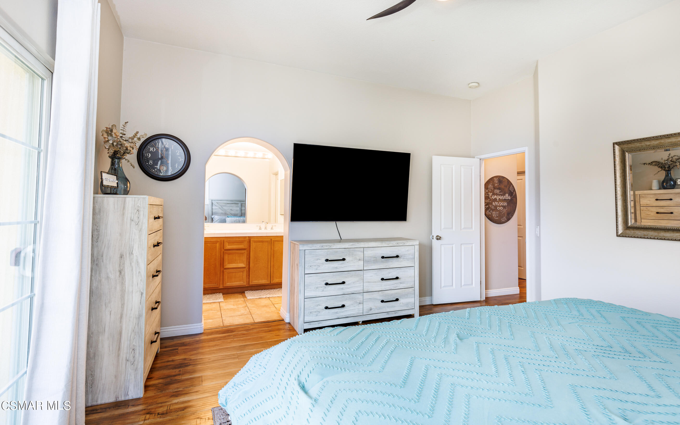 4121 Paredo Way, Unit A Simi Valley, CA 93063 - Photo 14 of 29 a view of a bedroom with wooden floor and mirror