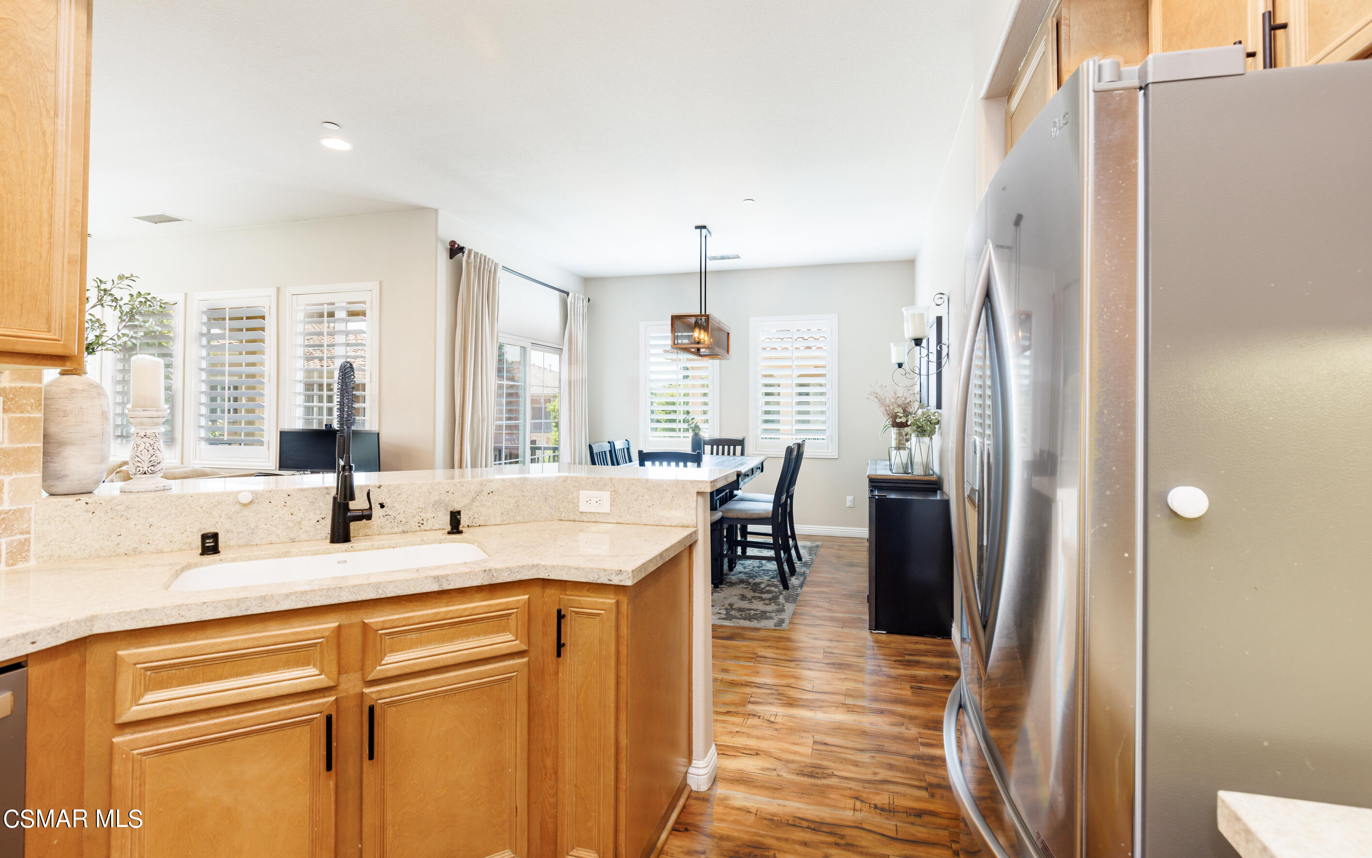 4121 Paredo Way, Unit A Simi Valley, CA 93063 - Photo 5 of 29 a kitchen with stainless steel appliances kitchen island granite countertop a refrigerator and a sink