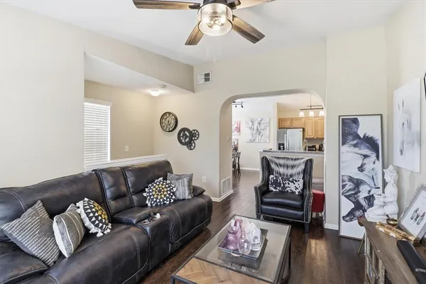 a living room with furniture and wooden floor