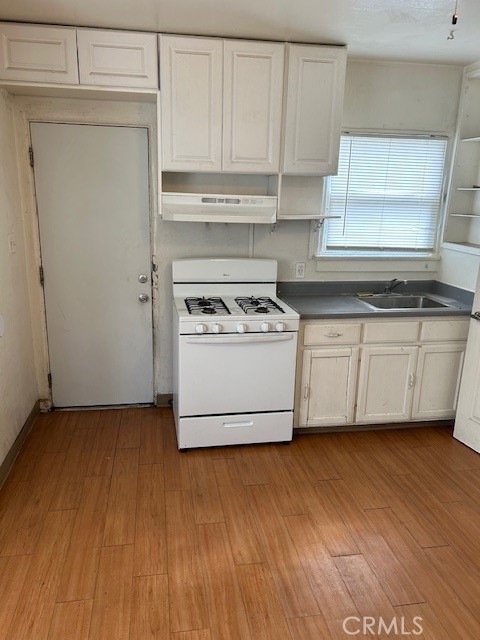 3159 1st Street Riverside, CA 92507 - Photo 6 of 9 a white kitchen with a stove top oven