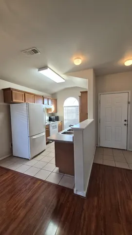 a living room with a couch and wooden floor