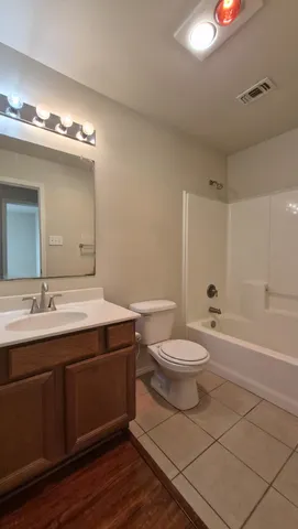 a bathroom with a toilet a sink and bathtub