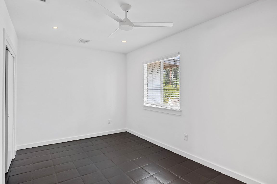 1200 Enfield Road, Unit 205 Austin, TX 78703 - Photo 12 of 22 an empty room with wooden floor and windows