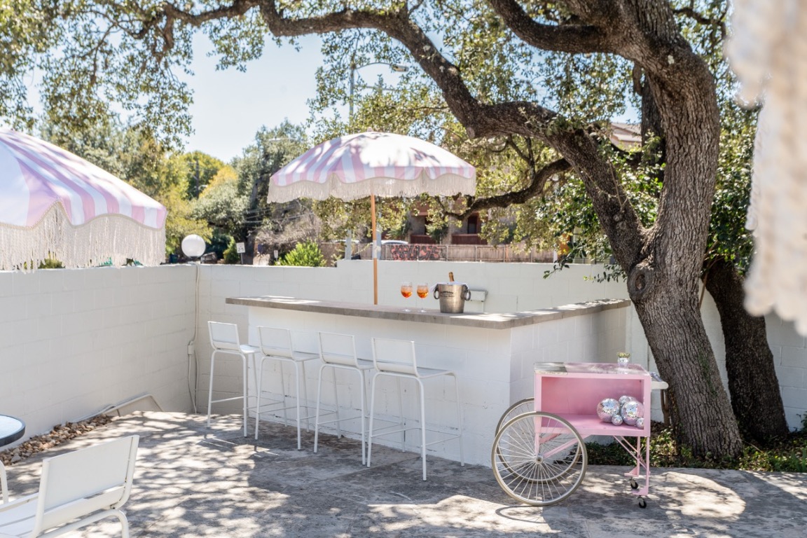 1200 Enfield Road, Unit 205 Austin, TX 78703 - Photo 22 of 22 a view of a patio with table and chairs under an umbrella