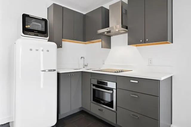 a kitchen with stainless steel appliances a stove microwave and refrigerator