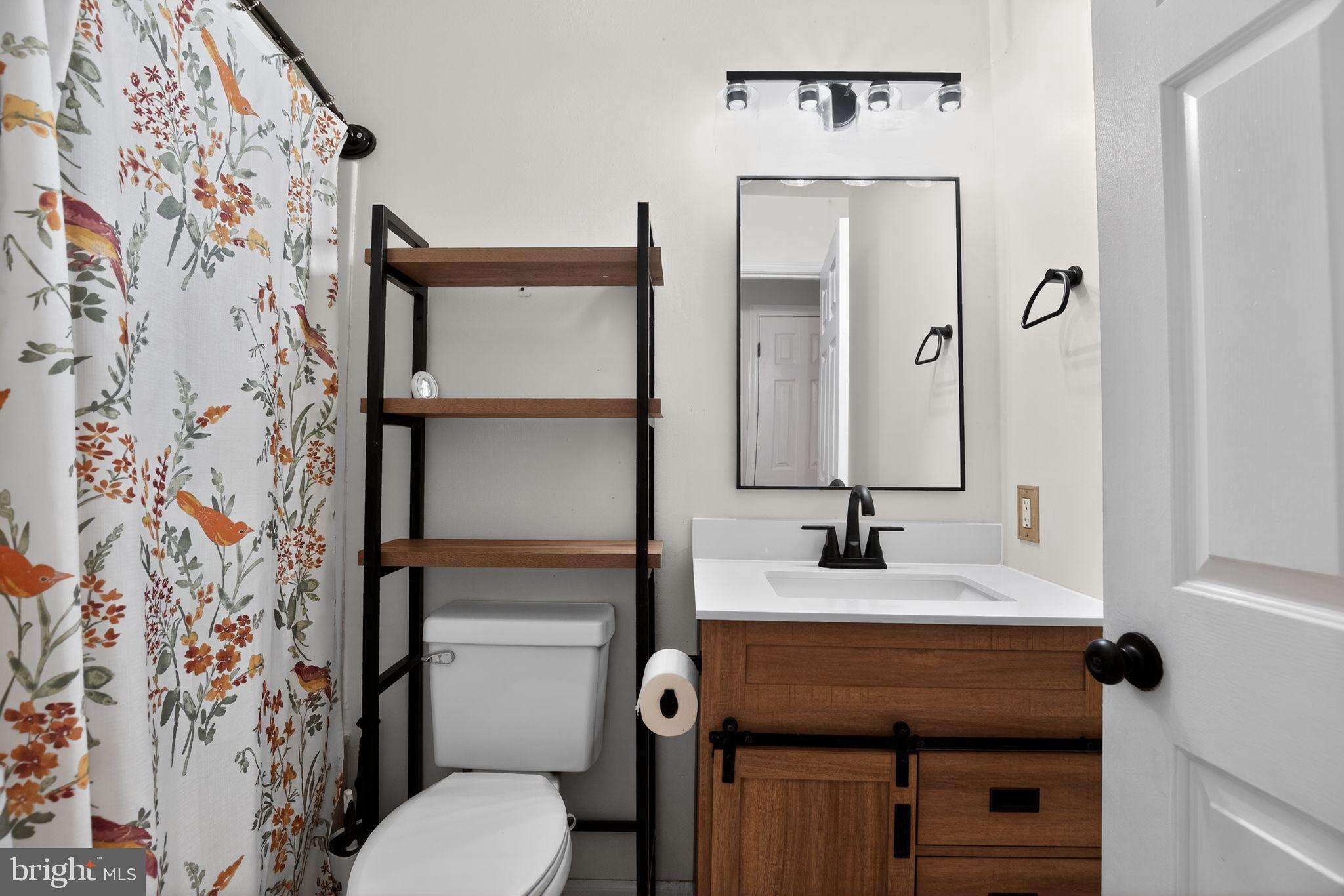 3240 Richfield Road Huntingtown, MD 20639 - Photo 14 of 33 a bathroom with a sink toilet and mirror