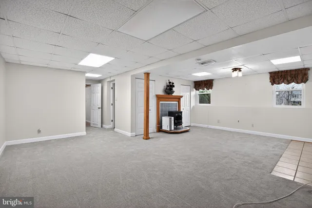 a view of a house with a yard covered in snow