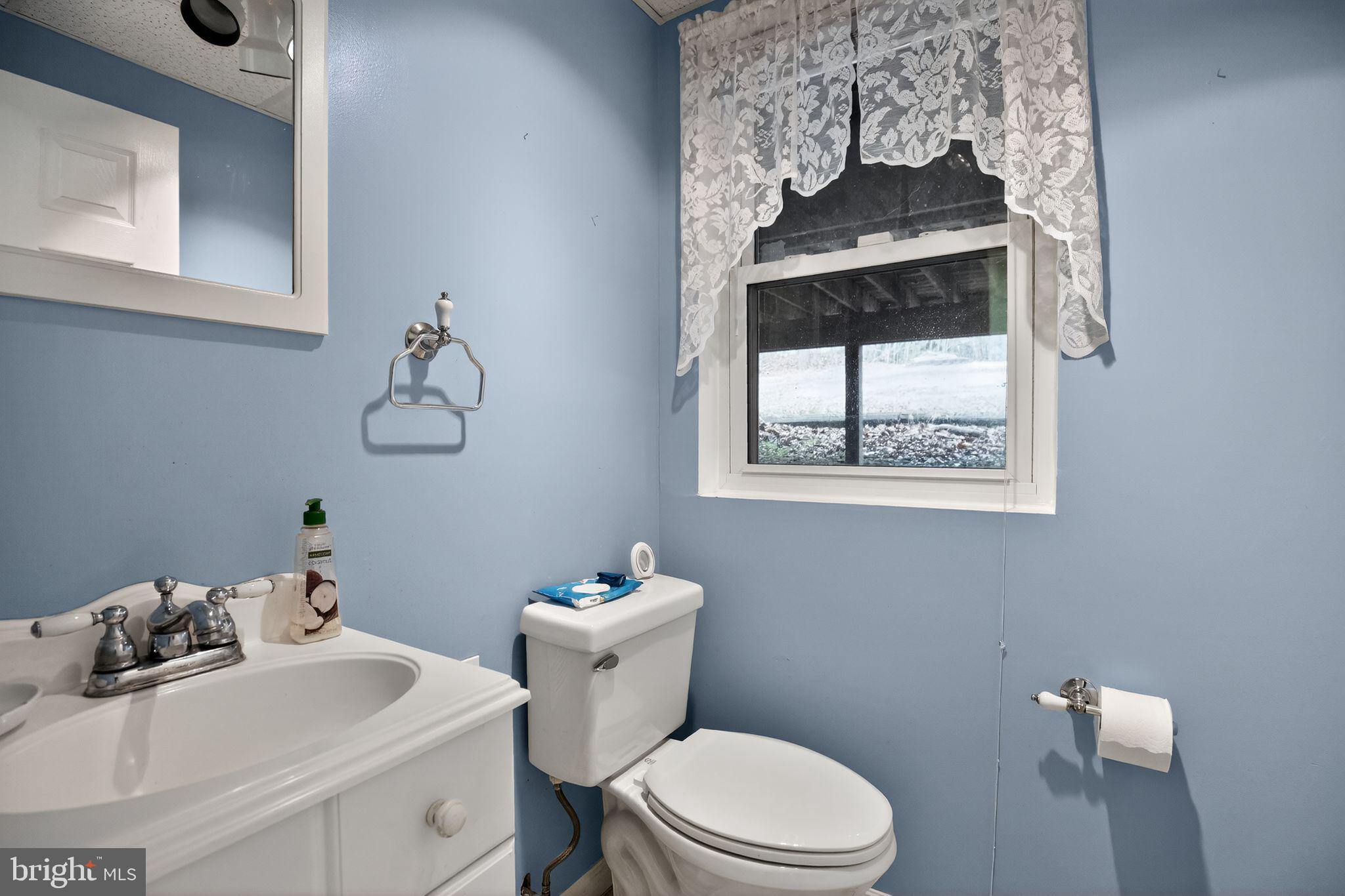 3240 Richfield Road Huntingtown, MD 20639 - Photo 19 of 33 a bathroom with a sink mirror and toilet
