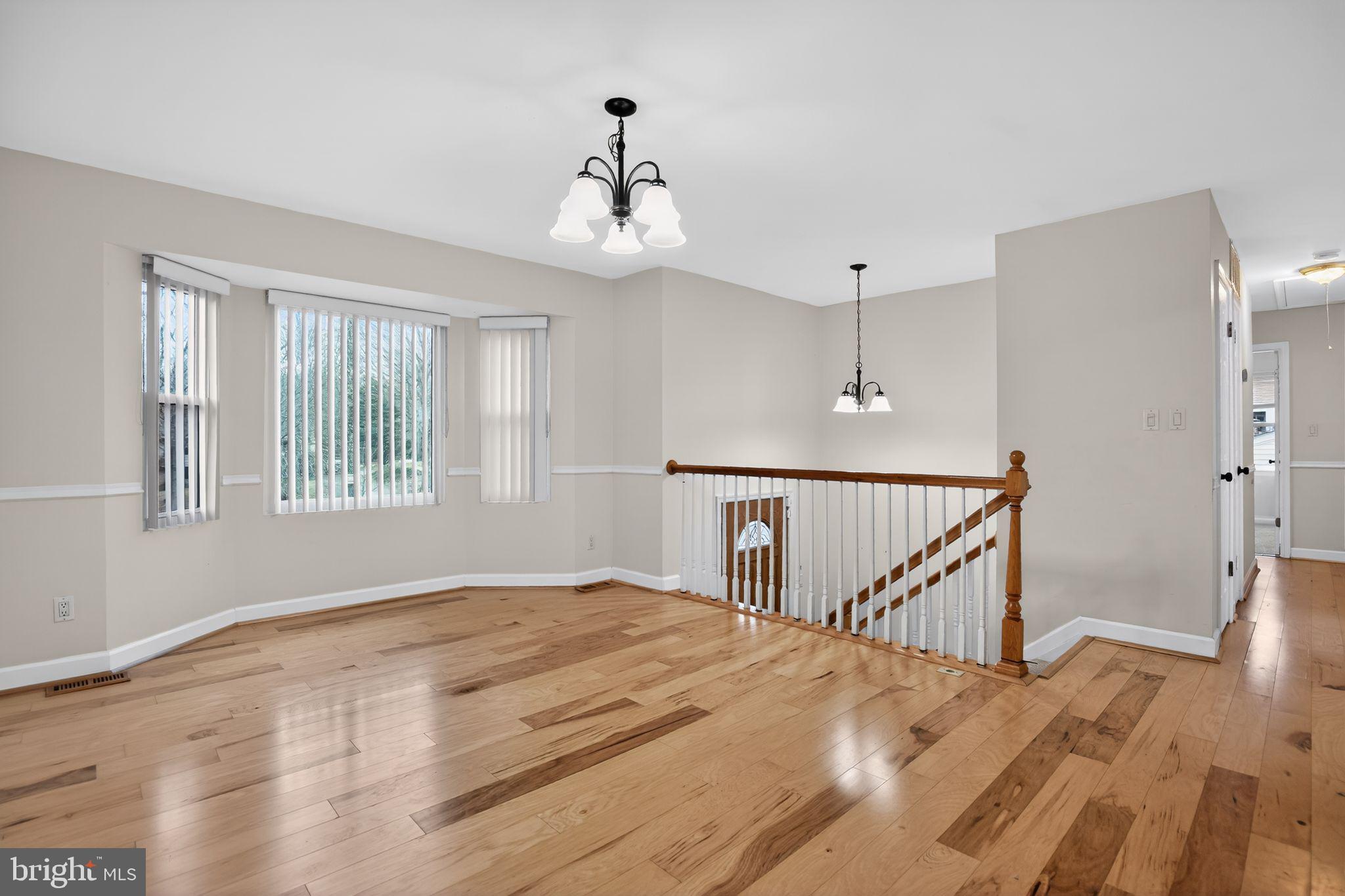 3240 Richfield Road Huntingtown, MD 20639 - Photo 2 of 33 a view of a bedroom with wooden floor and windows