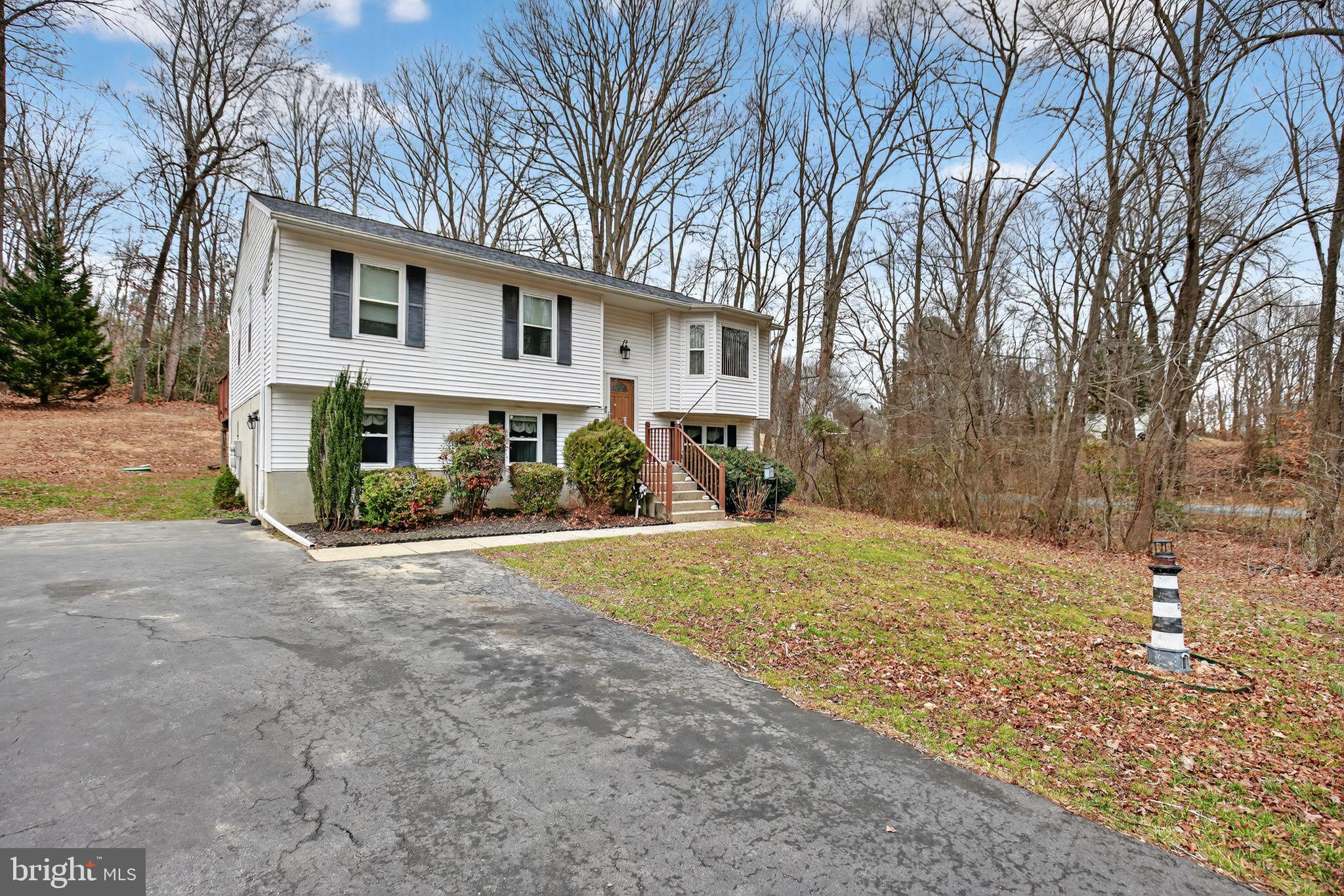 3240 Richfield Road Huntingtown, MD 20639 - Photo 22 of 33 a view of a house with a yard covered in snow