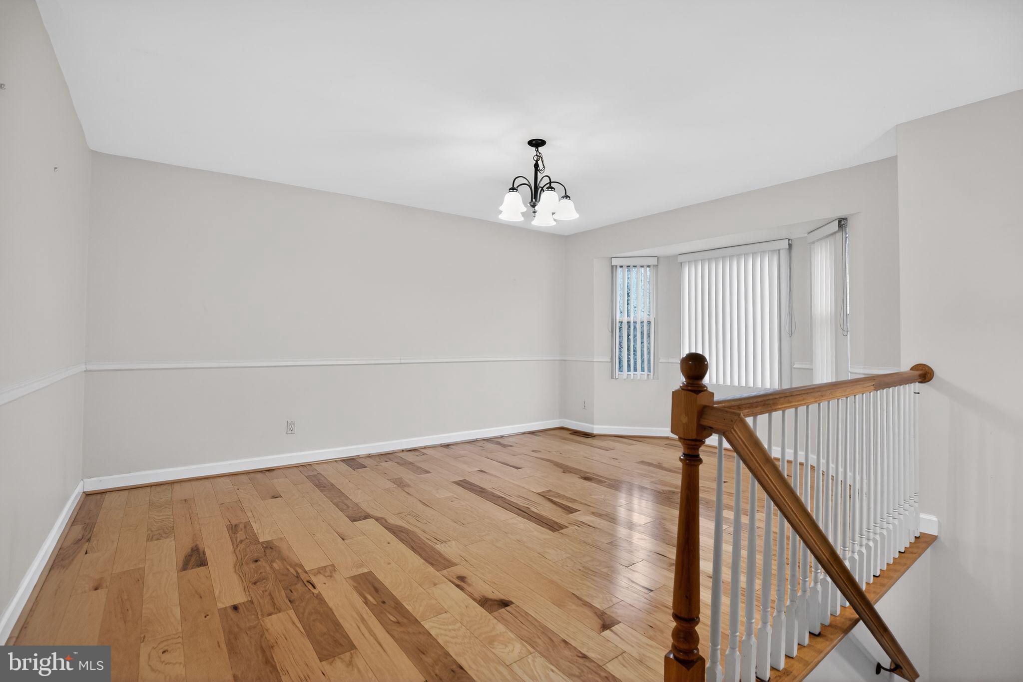 3240 Richfield Road Huntingtown, MD 20639 - Photo 4 of 33 a view of a livingroom with a chandelier fan and wooden floor