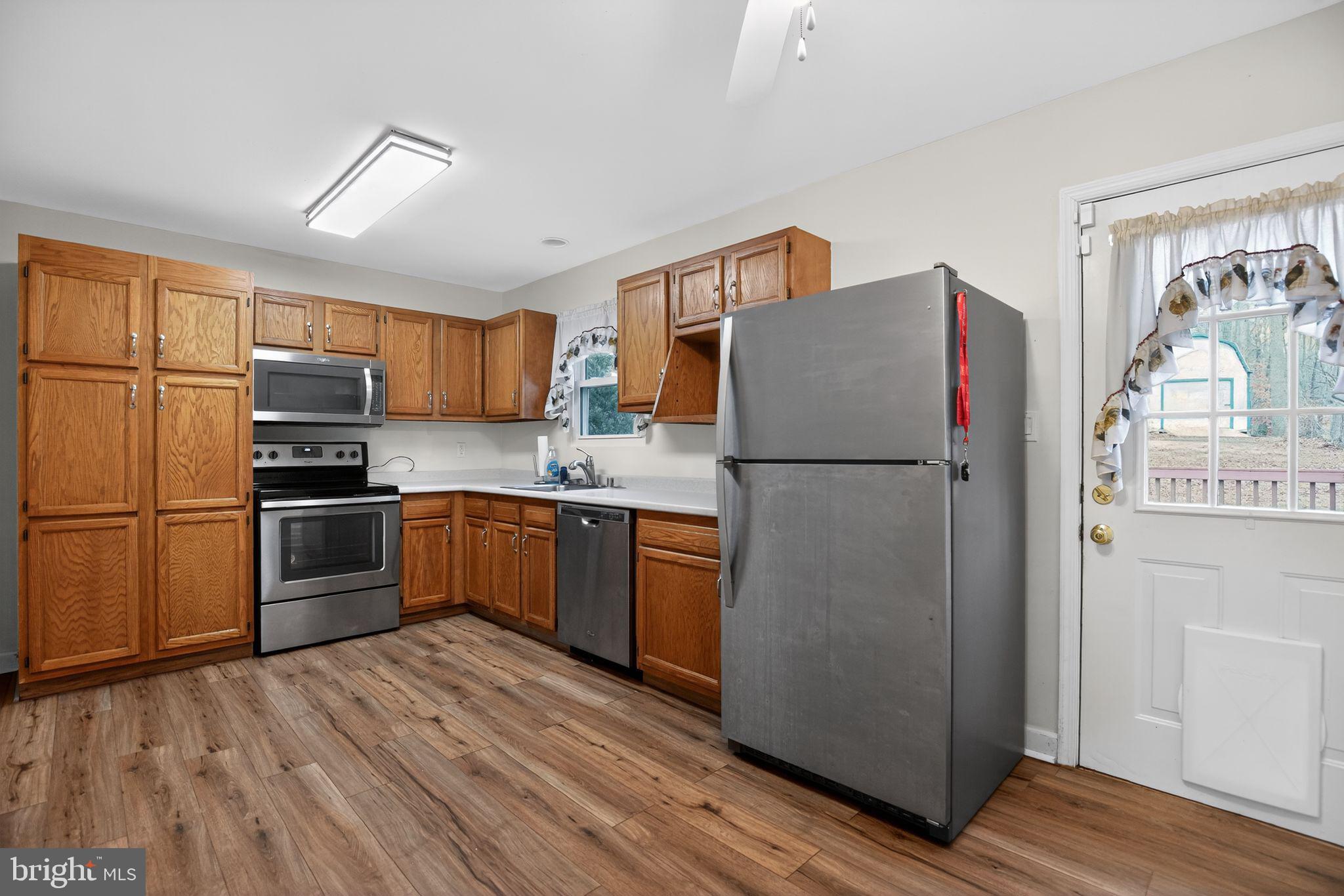 3240 Richfield Road Huntingtown, MD 20639 - Photo 5 of 33 a kitchen with stainless steel appliances a refrigerator sink and microwave