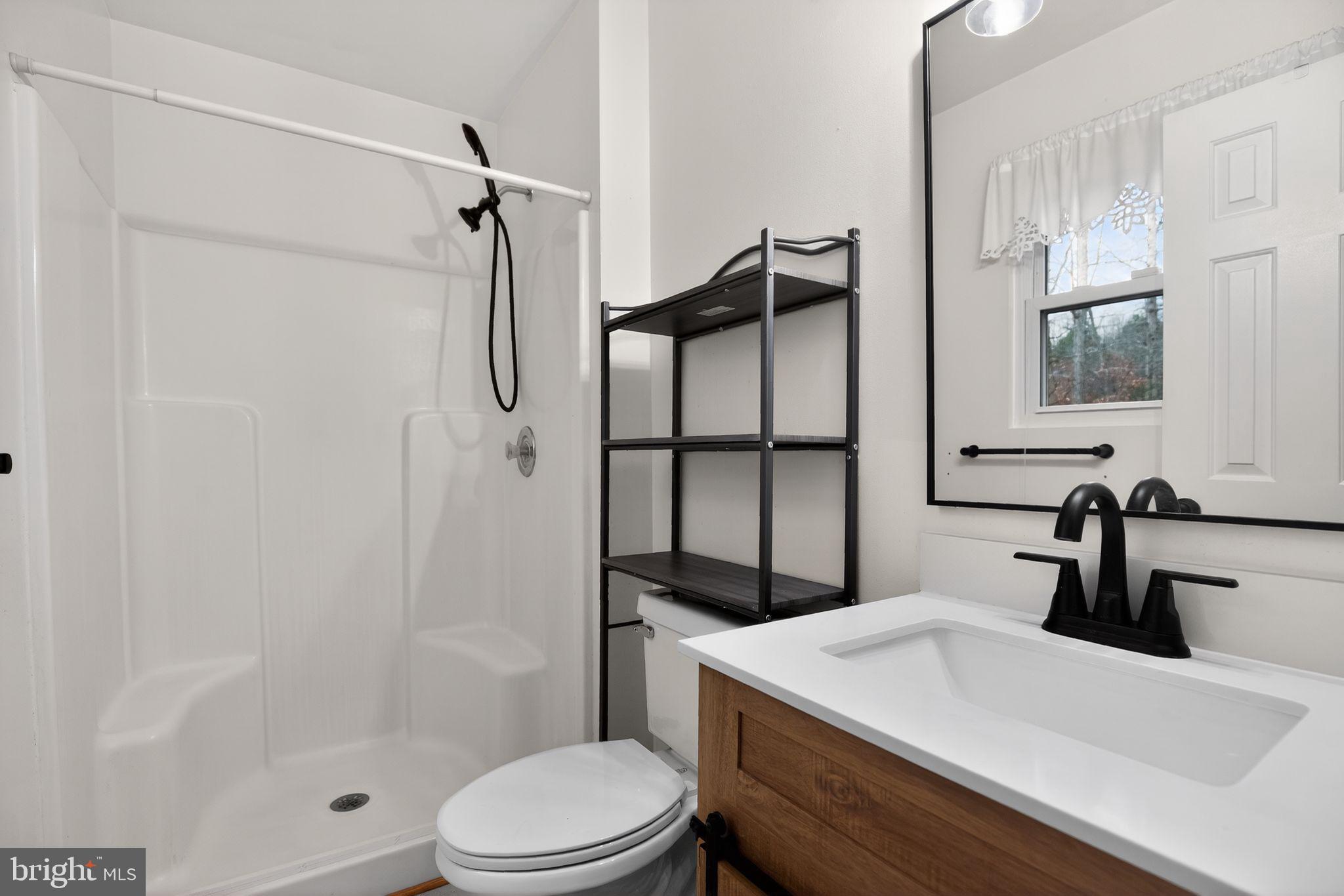 3240 Richfield Road Huntingtown, MD 20639 - Photo 10 of 33 a bathroom with a sink a toilet and shower