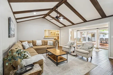 a living room with furniture and wooden floor