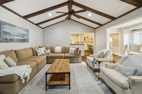 a living room with furniture and a ceiling fan