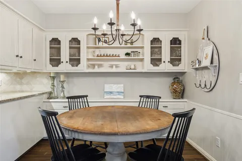 a view of a dining room with furniture and chandelier