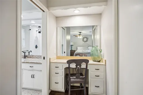 a bathroom with a granite countertop sink a mirror and shower