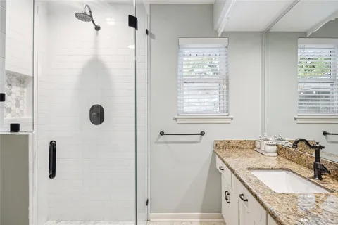 a bathroom with sink granite and a mirror