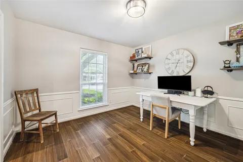 a bedroom with a bed couches and window
