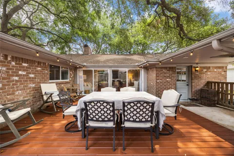 a view of a patio with table and chairs and wooden floor
