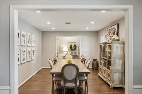 a dining room with furniture a window and wooden floor