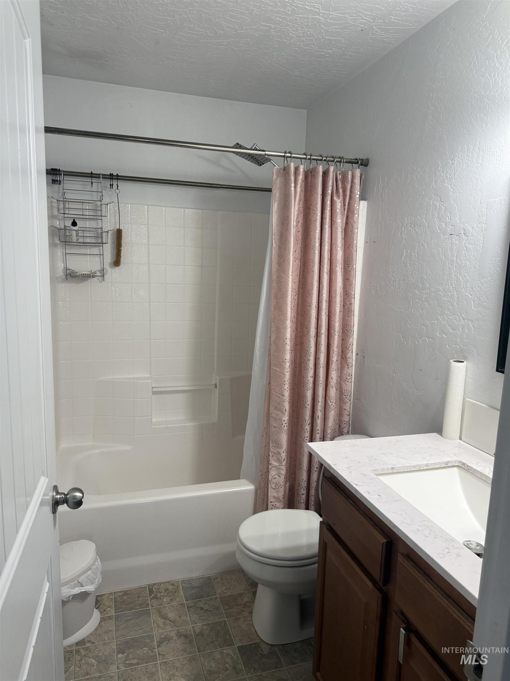 494 Adria Lane Twin Falls, ID 83301 - Photo 15 of 19 Full bathroom with a textured wall, vanity, shower / bath combination with curtain, and a textured ceiling