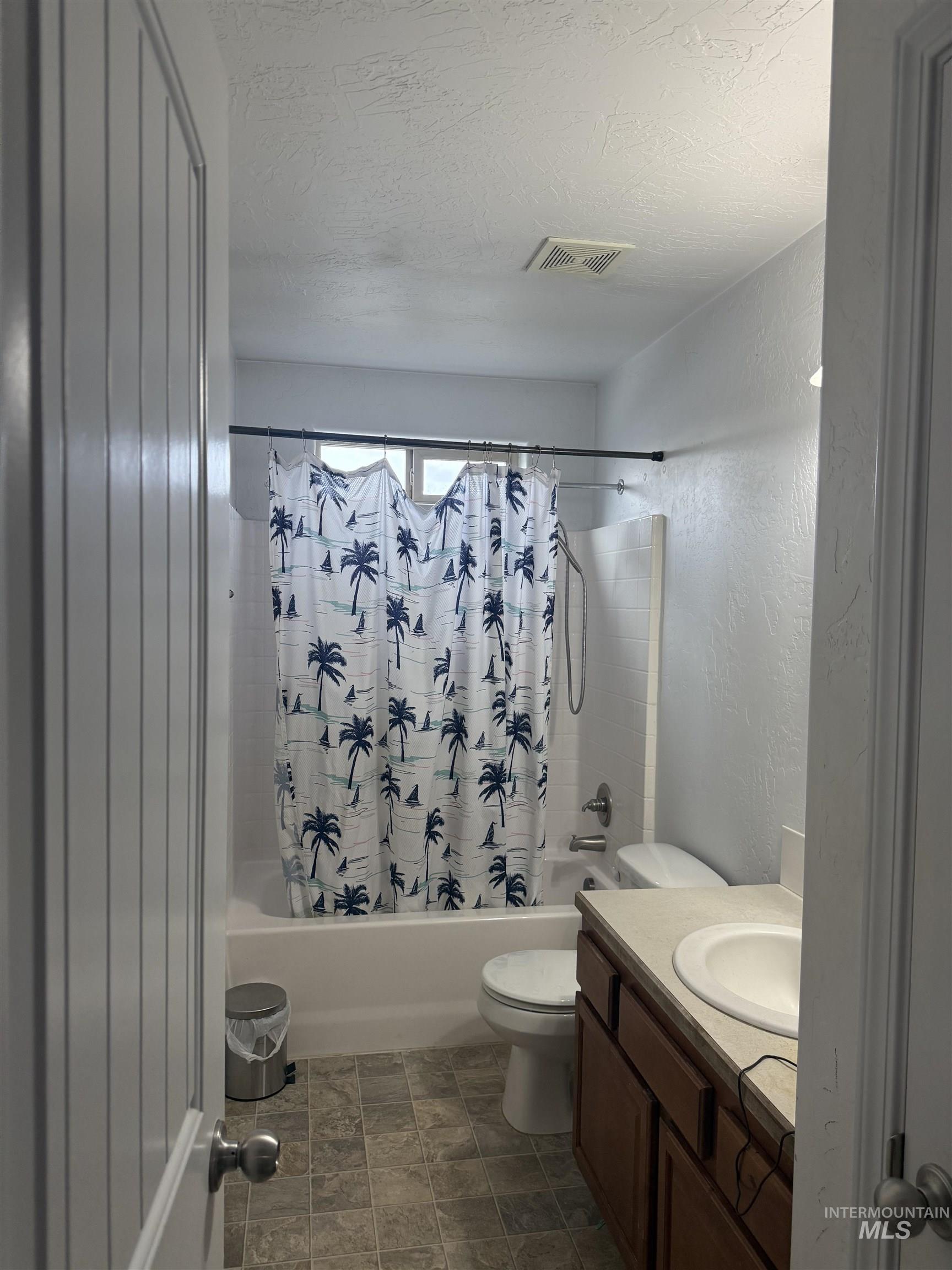 494 Adria Lane Twin Falls, ID 83301 - Photo 18 of 19 Full bath with shower / tub combo, vanity, a textured ceiling, and a textured wall