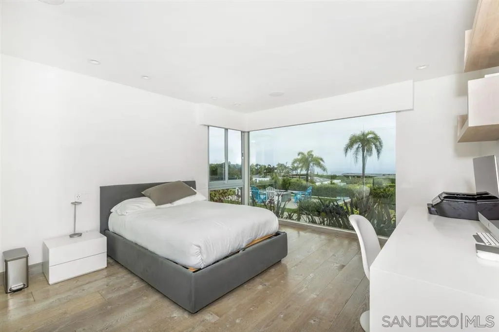 9648 Blackgold Road La Jolla, CA 92037 - Photo 14 of 25 a living room with a bed furniture and a large window