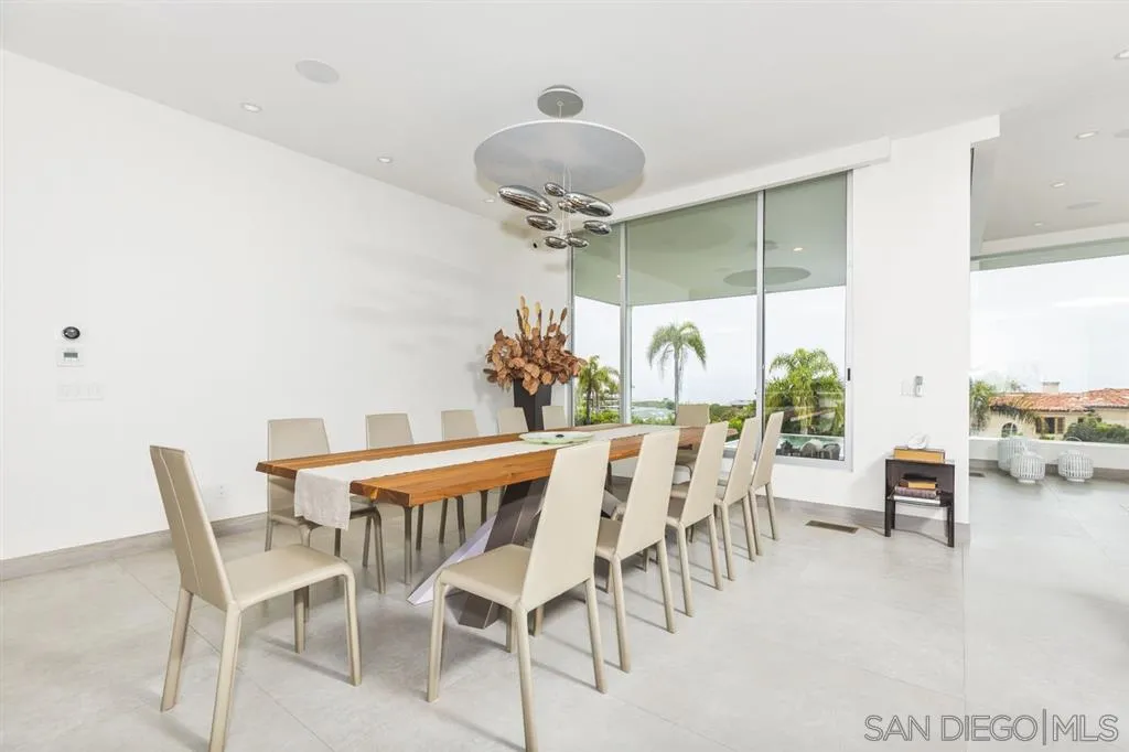 9648 Blackgold Road La Jolla, CA 92037 - Photo 6 of 25 a view of a dining room with furniture and chandelier