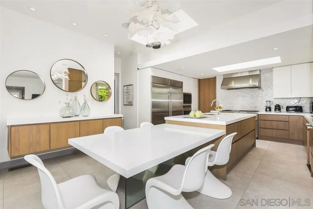 9648 Blackgold Road La Jolla, CA 92037 - Photo 7 of 25 a kitchen with a table chairs sink and cabinets