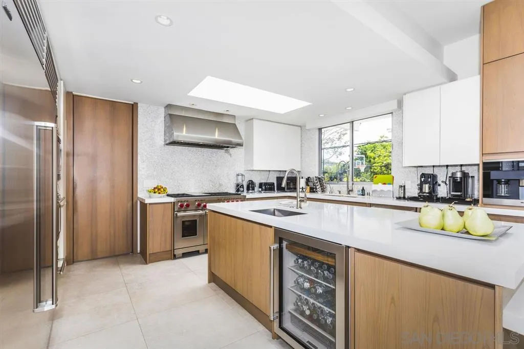 9648 Blackgold Road La Jolla, CA 92037 - Photo 8 of 25 a kitchen with a sink a counter top space cabinets and stainless steel appliances