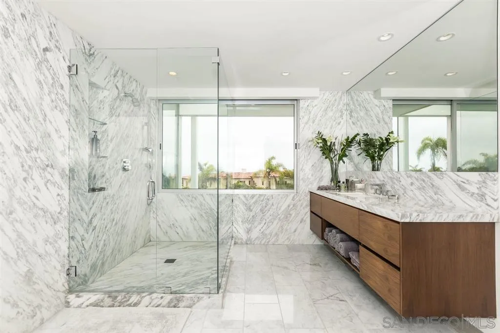 9648 Blackgold Road La Jolla, CA 92037 - Photo 10 of 25 a bathroom with a granite countertop sink a mirror and shower
