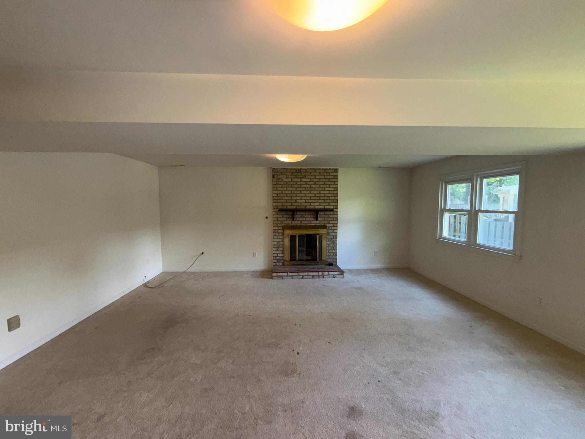 2133 Freda Drive Vienna, VA 22181 - Photo 25 of 35 an empty room with a fireplace and windows
