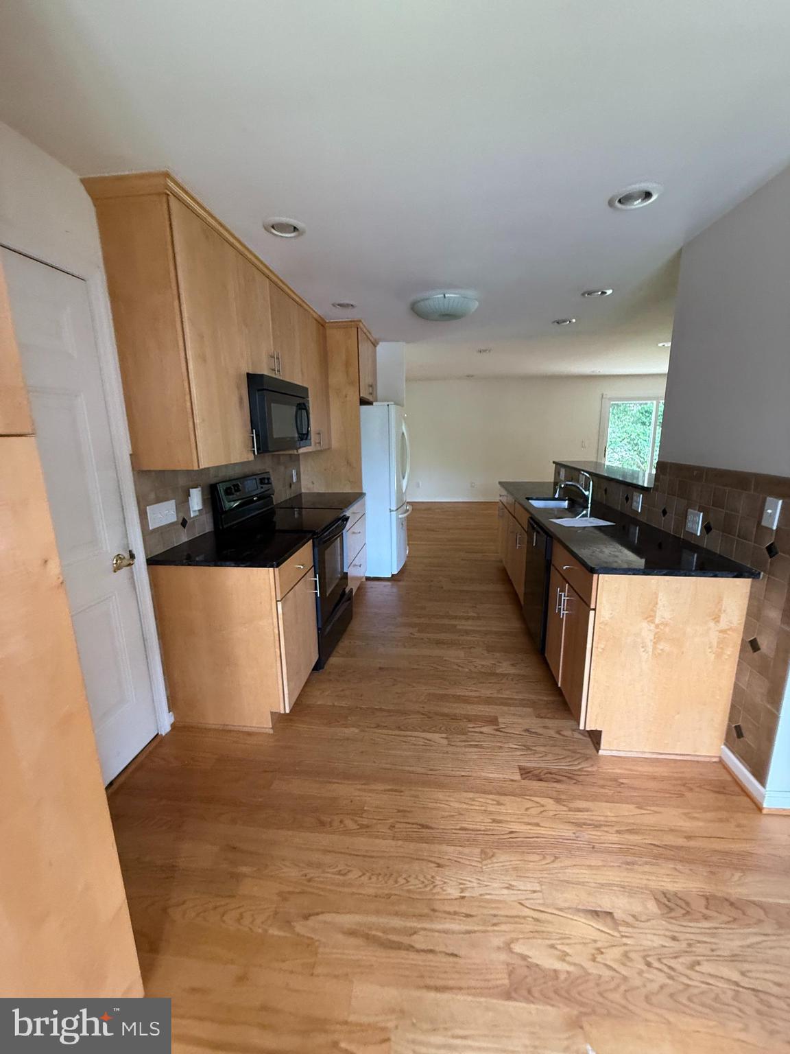 2133 Freda Drive Vienna, VA 22181 - Photo 5 of 35 a kitchen with stainless steel appliances granite countertop a sink a stove top oven a counter space and cabinets