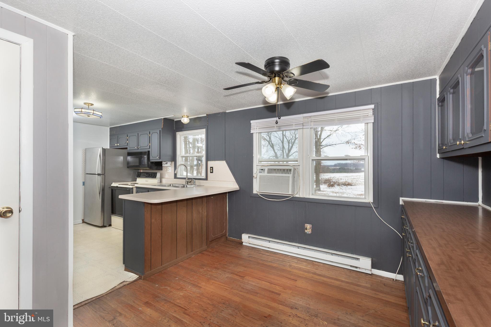 16 Leppo Road Westminster, MD 21158 - Photo 6 of 46 a kitchen with kitchen island a sink stainless steel appliances and window