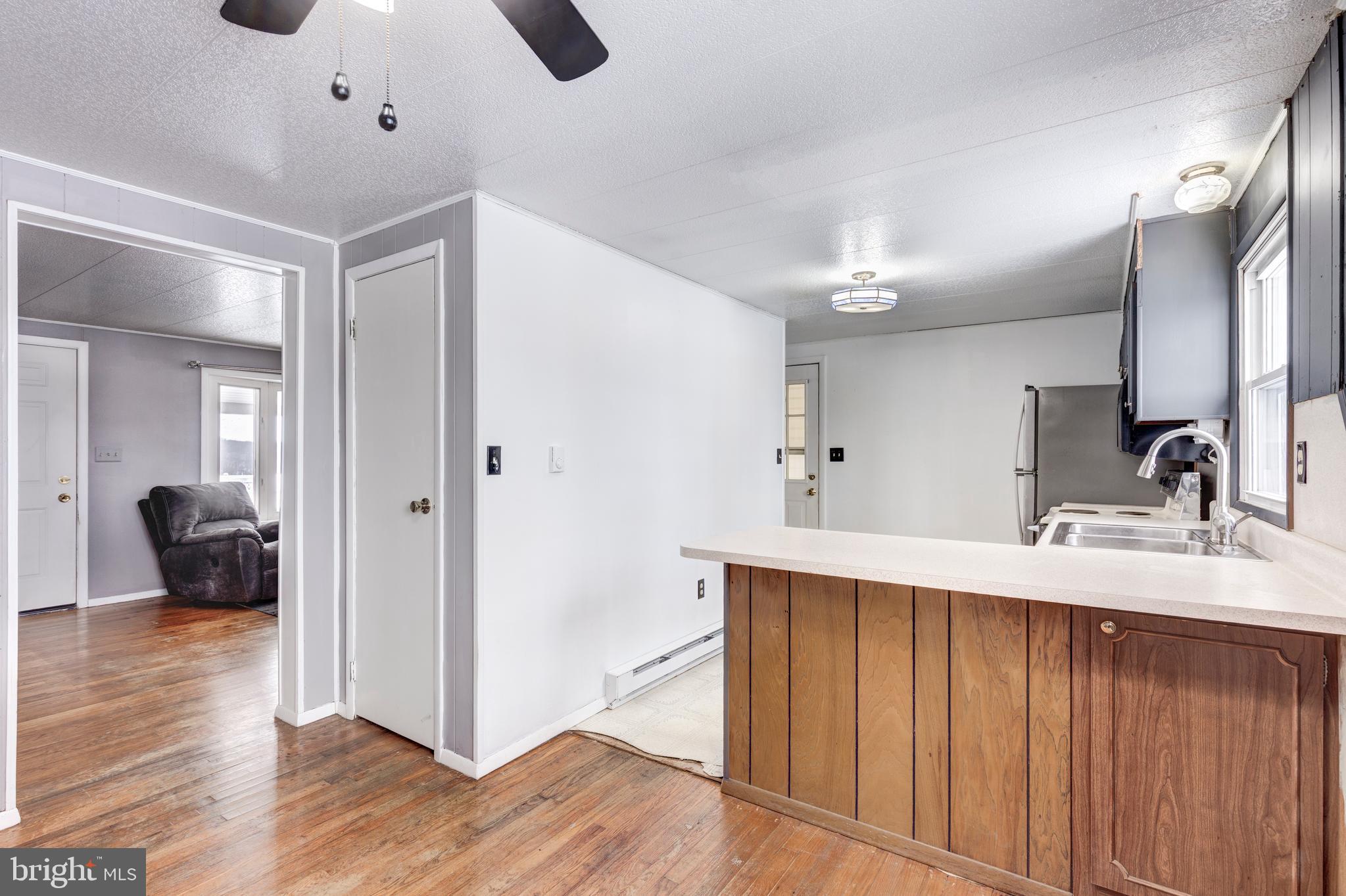 16 Leppo Road Westminster, MD 21158 - Photo 7 of 46 a kitchen with a sink a refrigerator and chairs