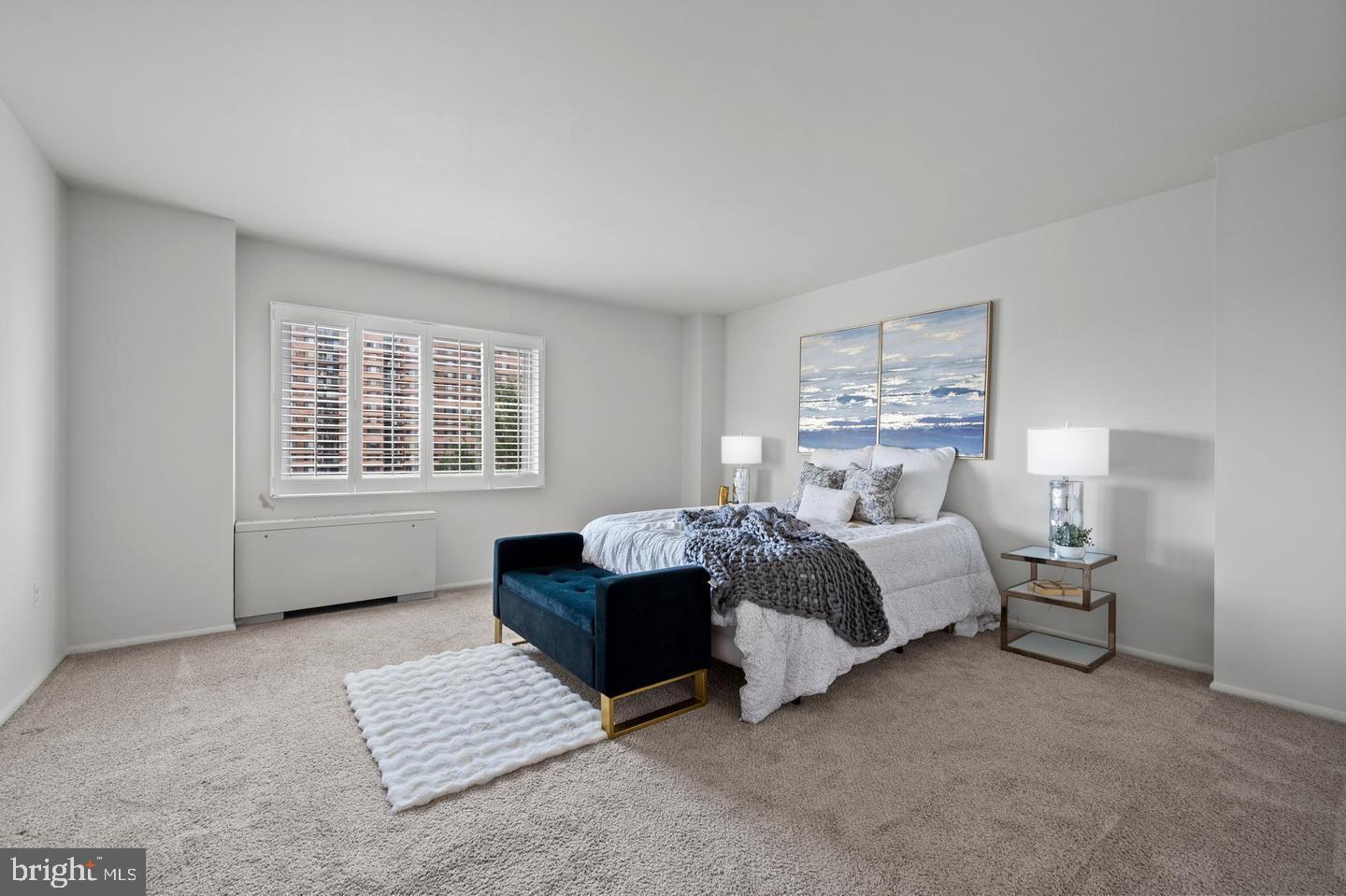 1111 University Boulevard West, Unit 815 Silver Spring, MD 20902 - Photo 11 of 14 a spacious bedroom with a bed and a window
