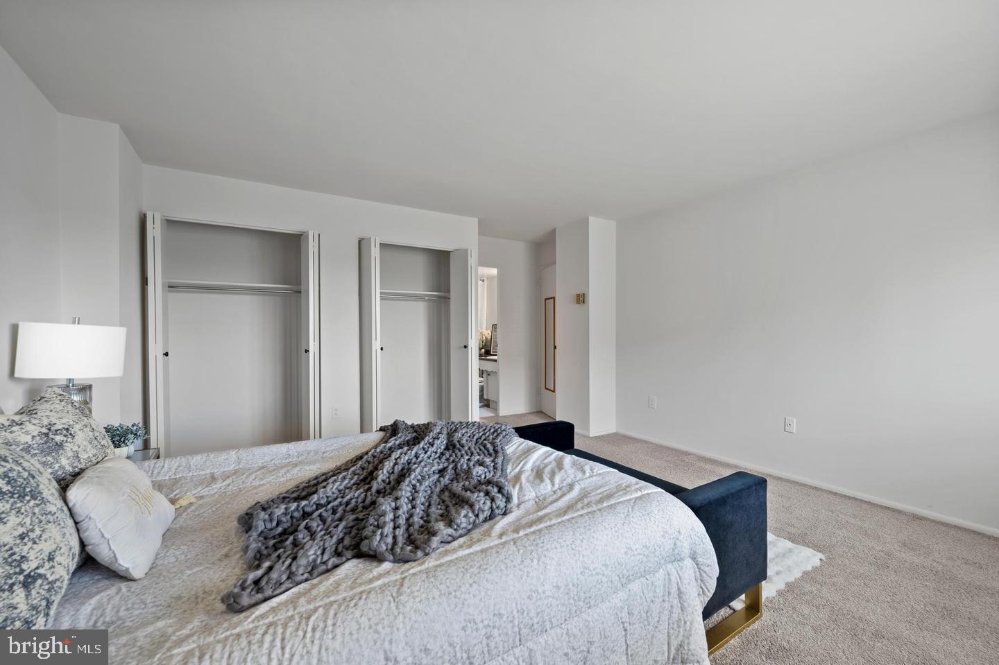 1111 University Boulevard West, Unit 815 Silver Spring, MD 20902 - Photo 12 of 14 a bedroom with a bed and a couch