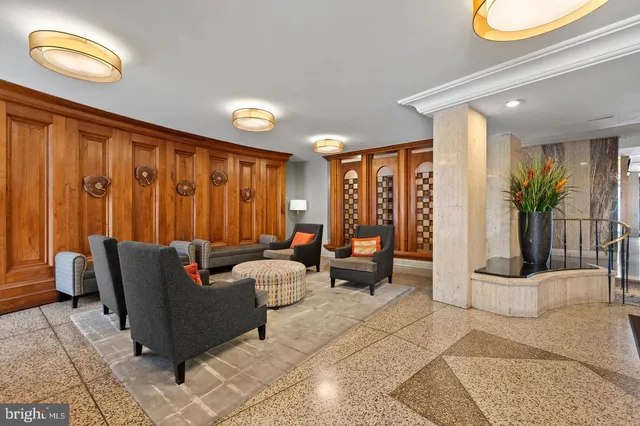 a living room with furniture and potted plants