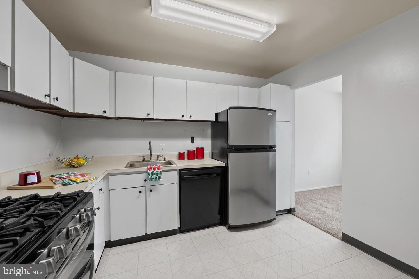 1111 University Boulevard West, Unit 815 Silver Spring, MD 20902 - Photo 5 of 14 a kitchen with a sink and cabinets