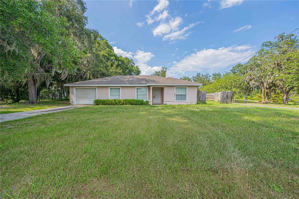 901 Southwest 7th Street Ocala, FL 34471 - Photo 20 of 27 a view of a house next to a big yard and large trees
