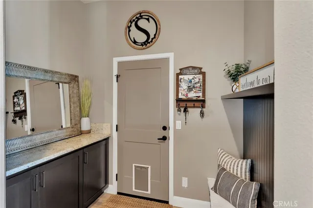 a bedroom with a bed a flat screen tv and a window