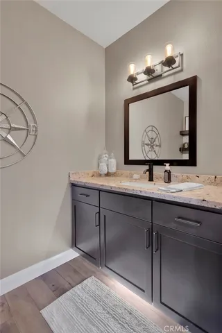 a bedroom with a bed a clock on the wall and a chandelier
