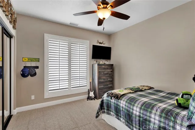 a bedroom with furniture and a mirror