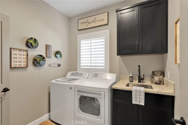a bedroom with a bed and a mirror on dresser with a potted plant