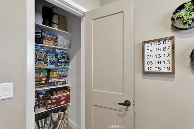 a bedroom with a bed and a clock on the wall