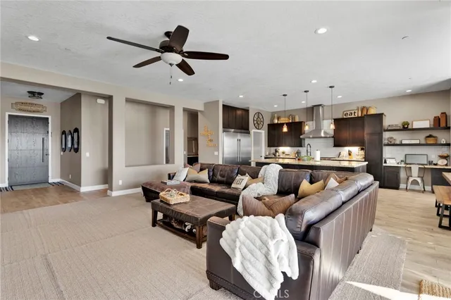 a living room with furniture and kitchen view