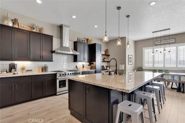 a kitchen with kitchen island granite countertop a sink center island cabinets and stainless steel appliances
